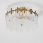 Hand-formed glass petal chandelier glowing softly overhead