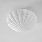 Another unlit angle shows the fine pleats on the shell-shaped shade of this Clérachic ceiling light.