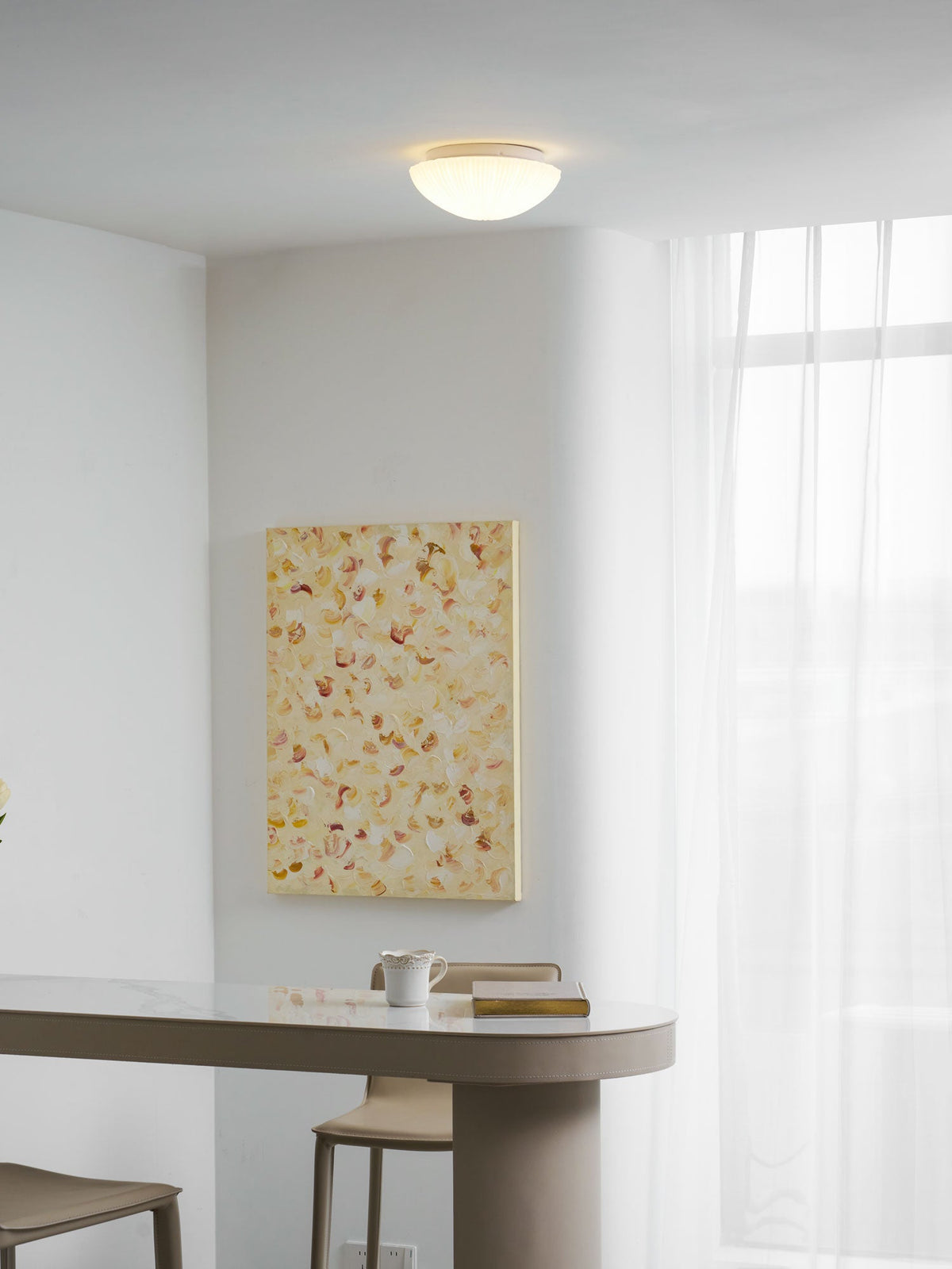 Glowing warm white in a room corner, this Clérachic ceiling light sits above sheer curtains and pale walls.