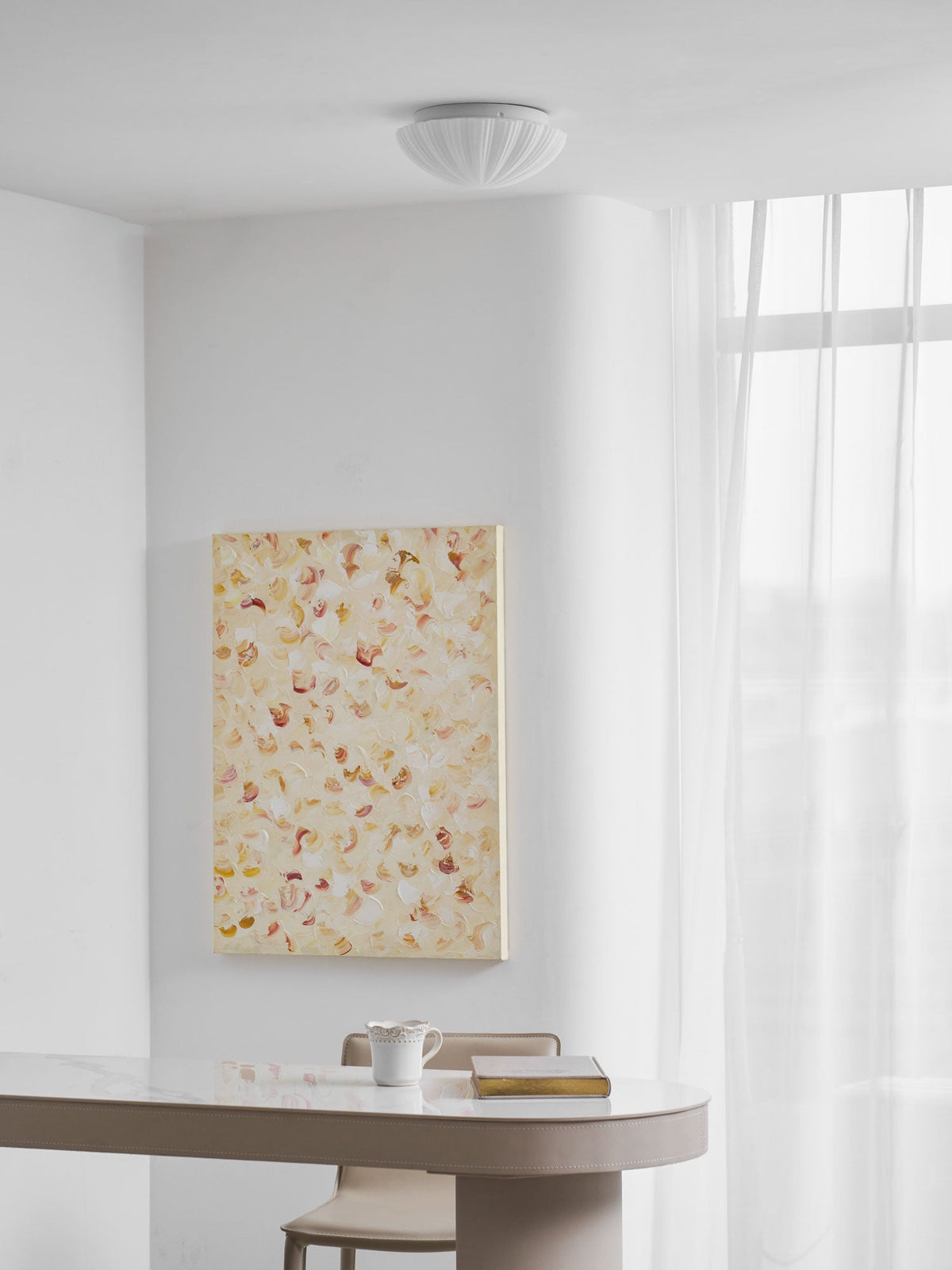 In a room corner, this Clérachic ceiling light glows warm white above pale walls and sheer curtains.
