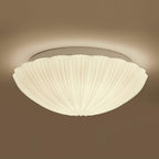 In side profile against a warm brown backdrop, this Clérachic ceiling light glows softly from within.