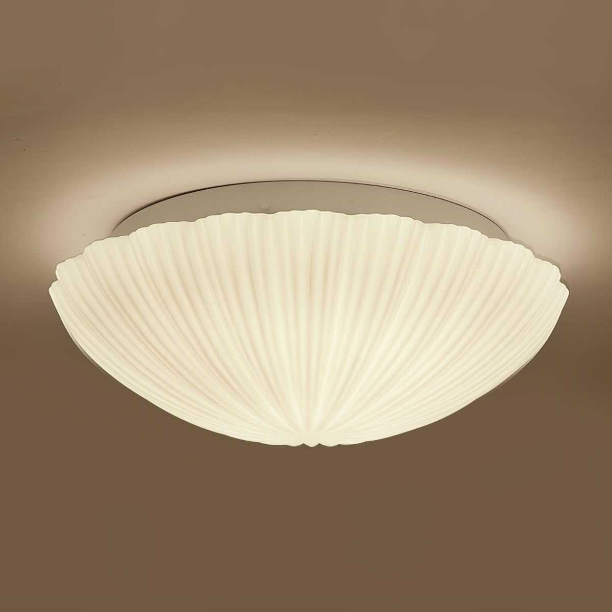 In side profile against a warm brown backdrop, this Clérachic ceiling light glows softly from within.