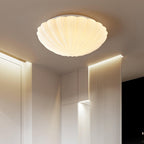Set flush to a slatted wood ceiling, this Clérachic light casts a warm glow across the room below.