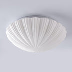 Unlit on a plain grey backdrop, this Clérachic ceiling light shows the scalloped edge of its shade in side view.