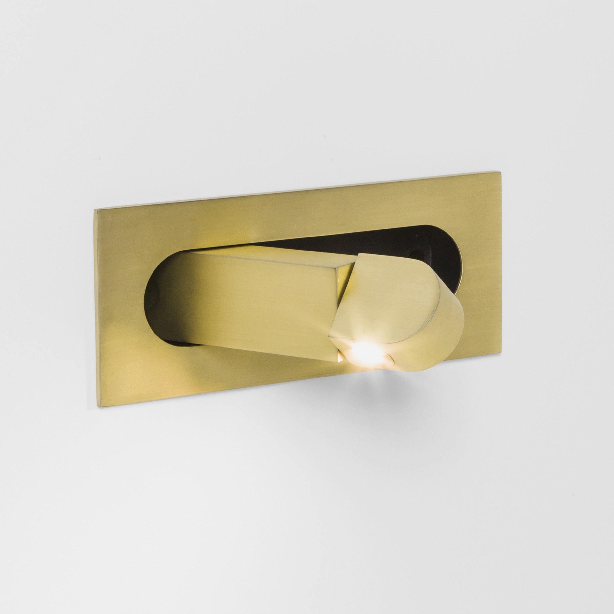 Gold LED bedside reading light mounted on the right side