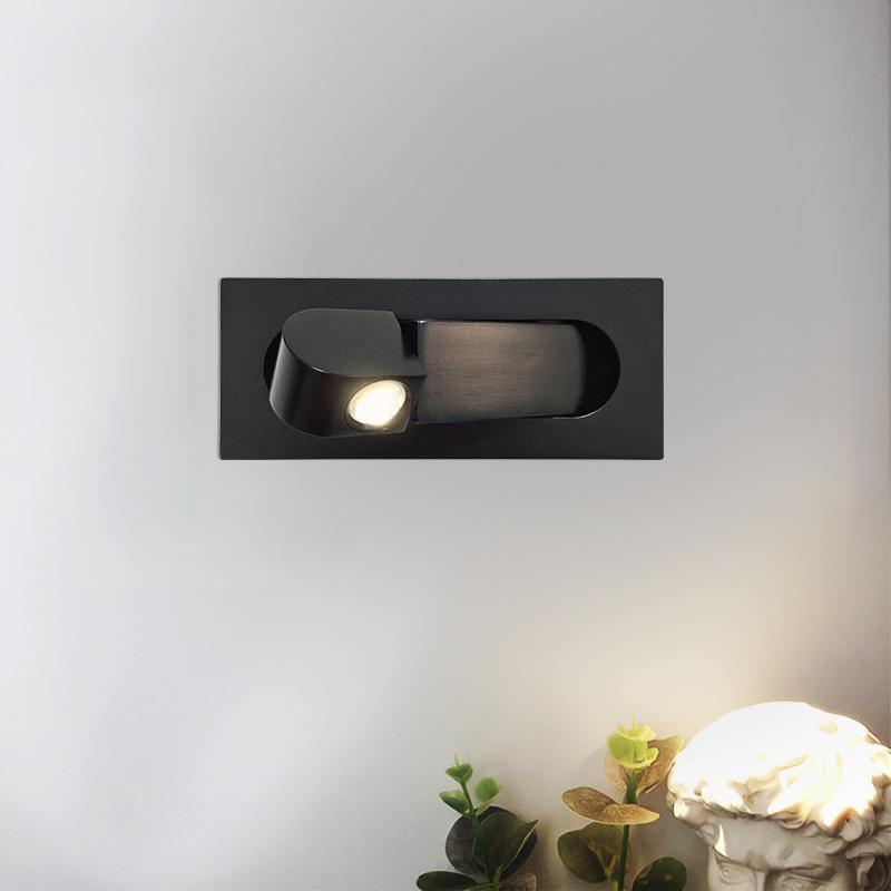 Modern LED bedside reading light in matt black, mounted left of a bed