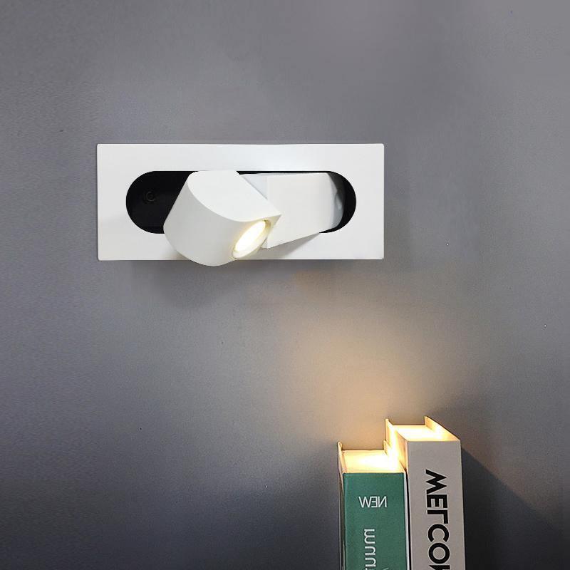 Modern LED bedside reading light in matt white, wall-mounted by a bed