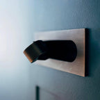 LED bedside reading light side profile against the wall