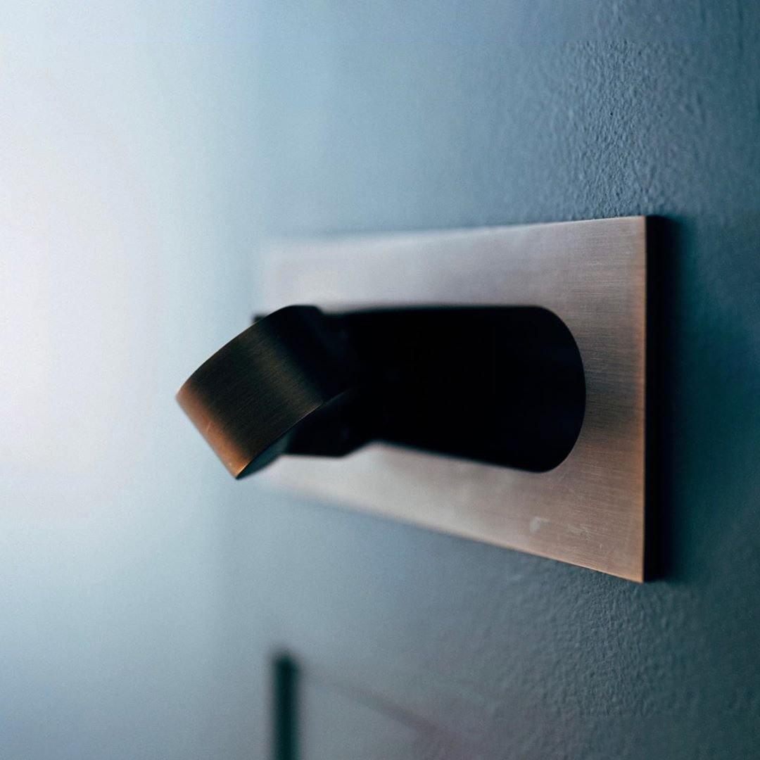 LED bedside reading light side profile against the wall
