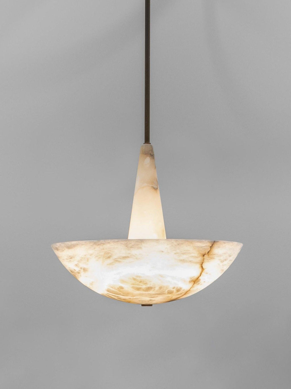 The pendant on grey, shown at full drop with its slim dark rod above the conical stem and bowl.