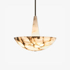 Closer view of the alabaster bowl pendant on white, dark veining running right across the lit stone.