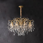 The same chandelier fuller on dark grey, more crystal leaves massed beneath the lit brass arms.