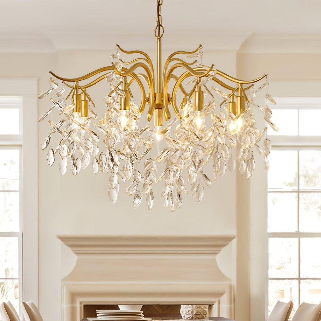 The chandelier lit in a cream room above a painted fireplace, tall windows on either side.
