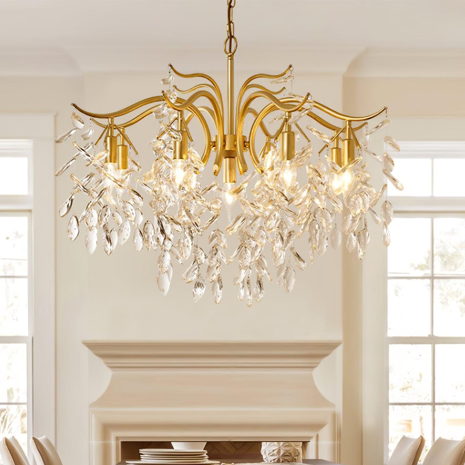 The chandelier lit in a cream room above a painted fireplace, tall windows on either side.