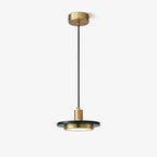 A Clérachic pendant light on white, showing its gold ceiling cap, black cord and black-and-gold shade.
