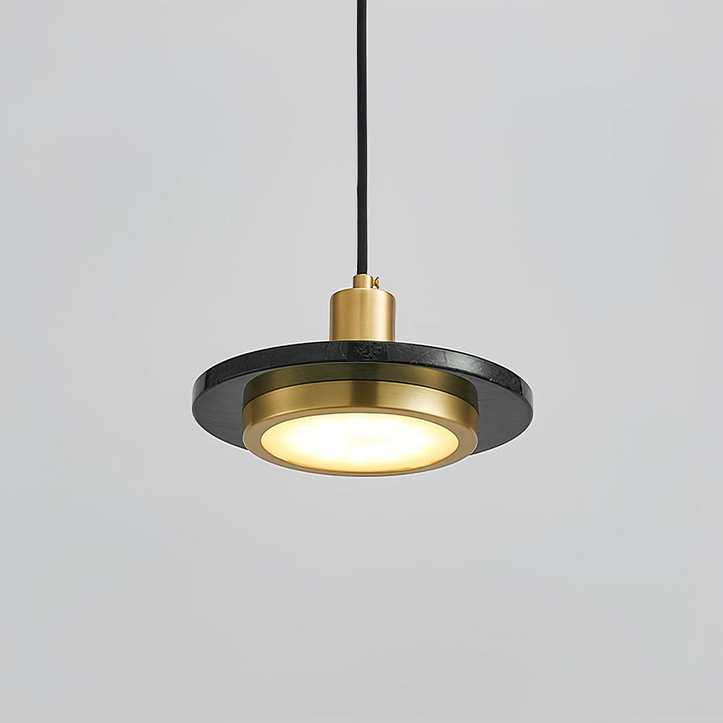 Underside view of a Clérachic pendant light, its glowing LED ring framed by a black-and-gold rim.