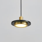 Underside view of a Clérachic pendant light, its glowing LED ring framed by a black-and-gold rim.