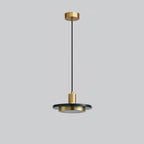 Dark stone disc pendant suspended on a long cord against a plain grey backdrop, the whole drop shown top to bottom for this Clérachic light.