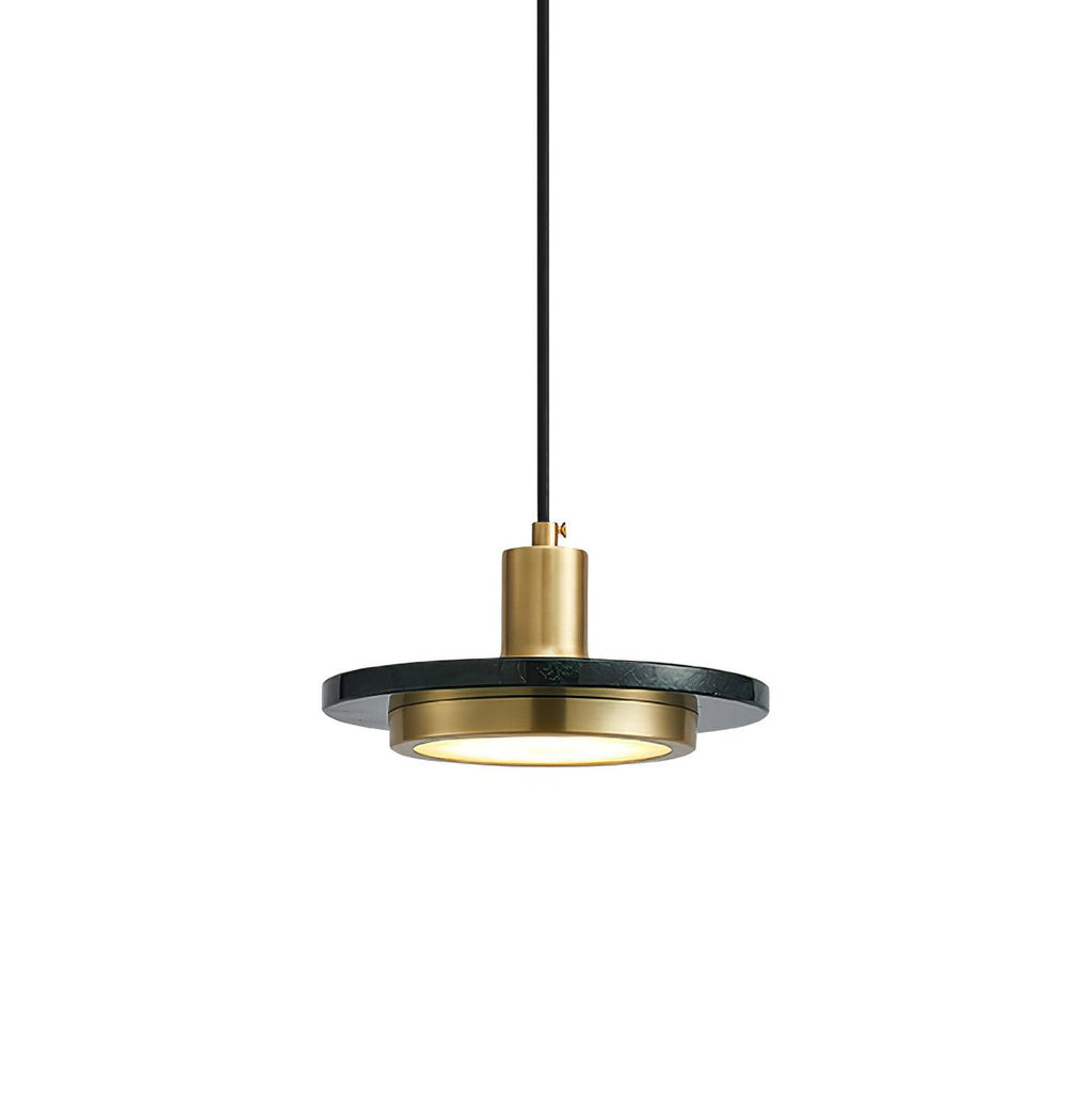 Dark green-black stone disc pendant glowing warm at its centre, photographed at a slight angle on white for this Clérachic light.