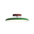 Swing-arm ceiling lamp with acrylic shade in a styled interior