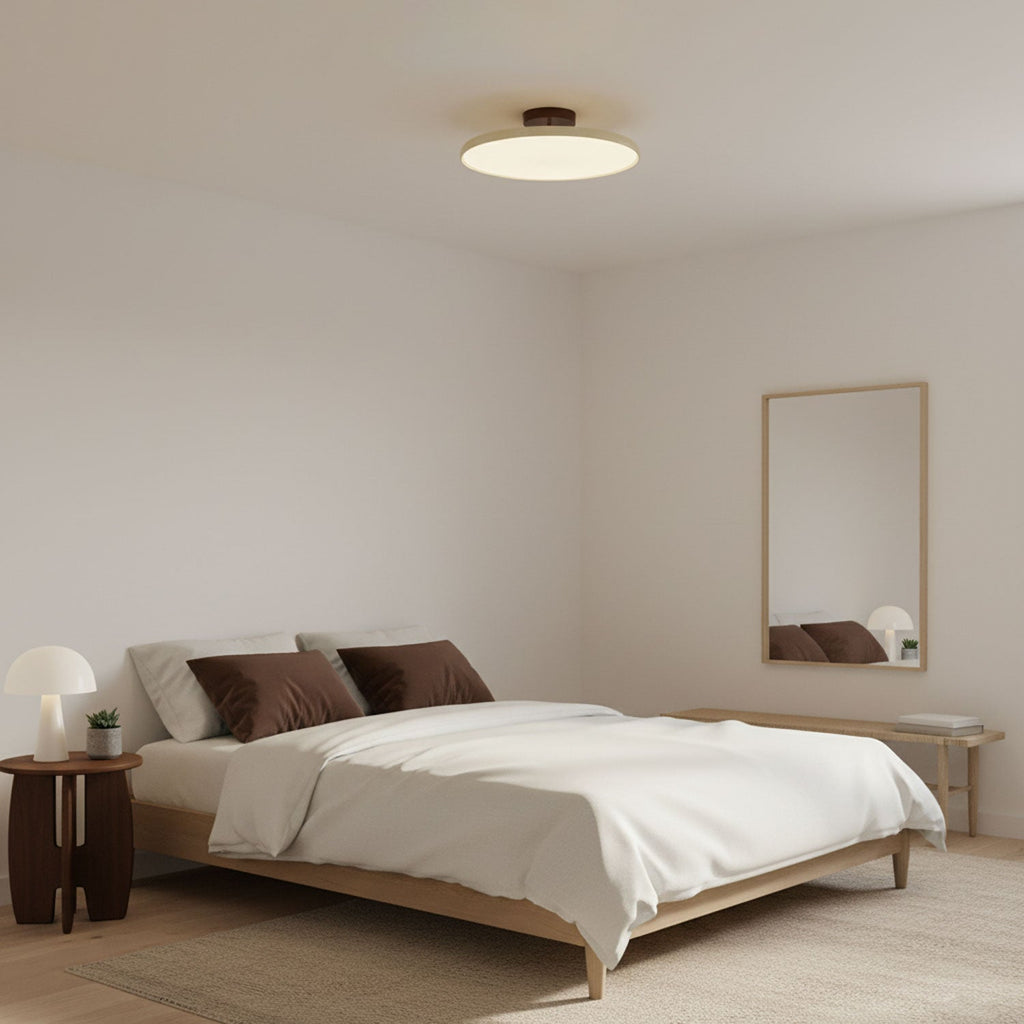 Round swing-arm ceiling lamp casting soft light in a room