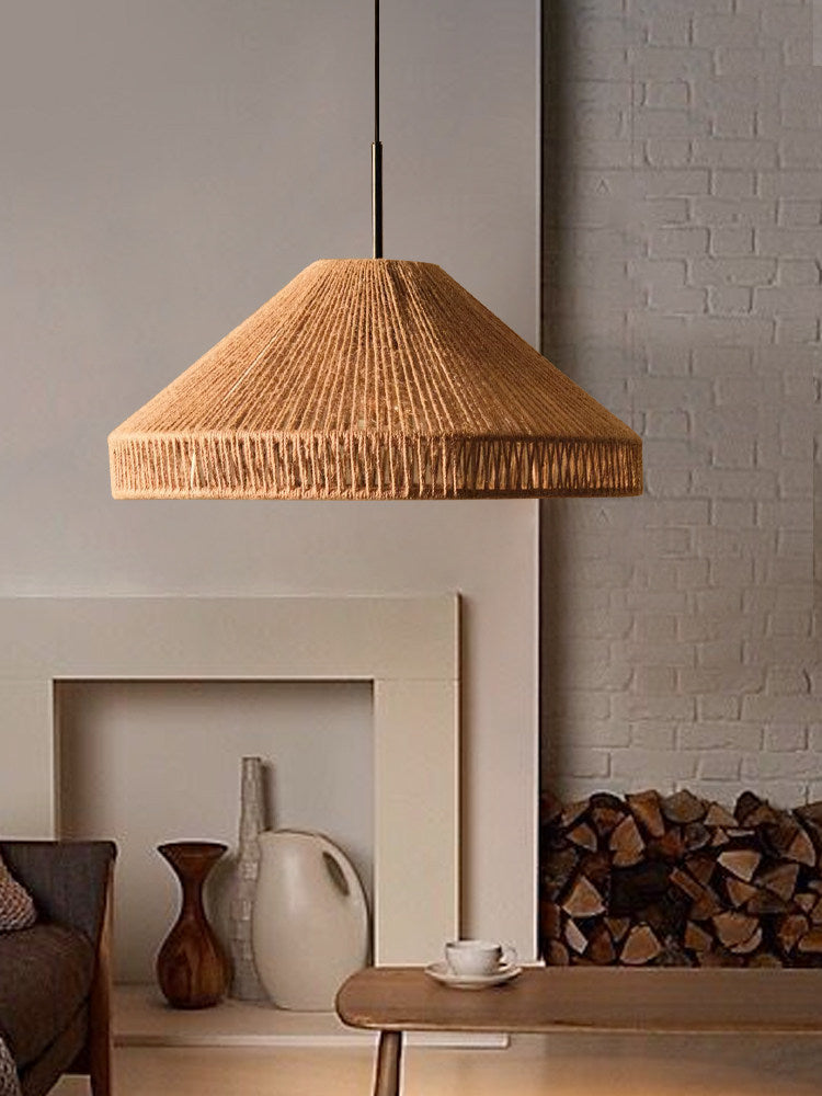 Near a stone fireplace mantel styled with ceramic vases and stacked firewood, this Clérachic pendant hangs above a low table.