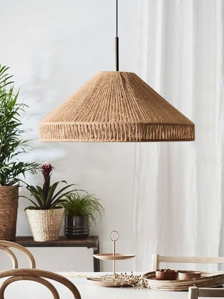 This Clérachic pendant hangs near a sheer curtain, potted plants arranged on a tiered stand below.