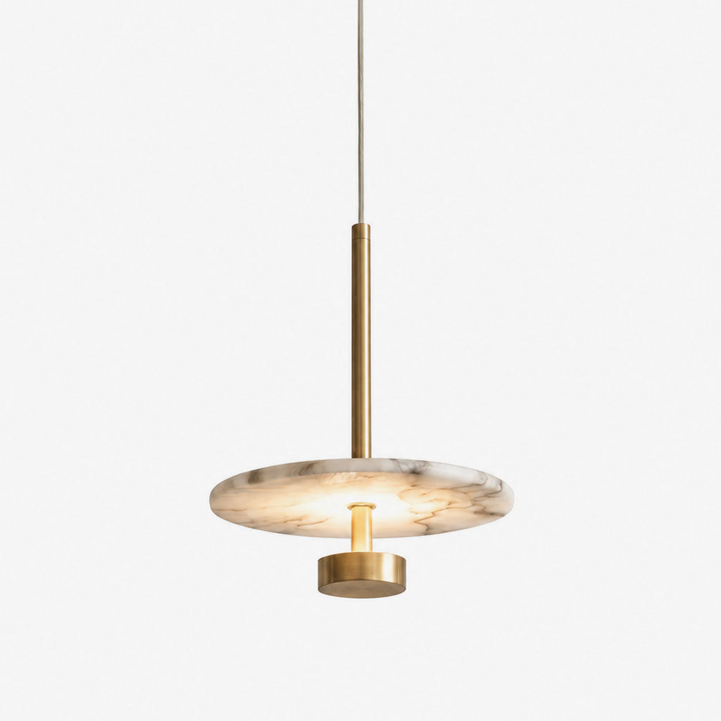 Photographed in brushed brass against white, this Clérachic pendant suspends its round alabaster disc from a slender stem.