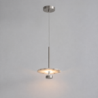 In brushed nickel, this Clérachic pendant hangs its flat alabaster disc from a slim rod against grey.