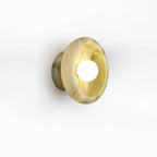 Clérachic wall sconce in golden amber jade, photographed at an angle on a white studio background.