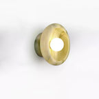 Clérachic golden jade wall sconce cropped closer on a white background, showing the stone's grain.
