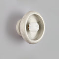 Clérachic wall sconce in veined white marble, its grey striations visible around the glowing central bulb.