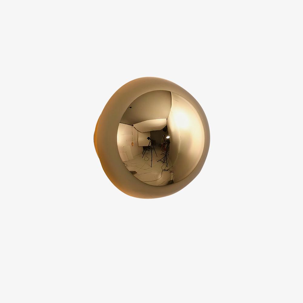 Polished sphere wall sconce mounted as wall art