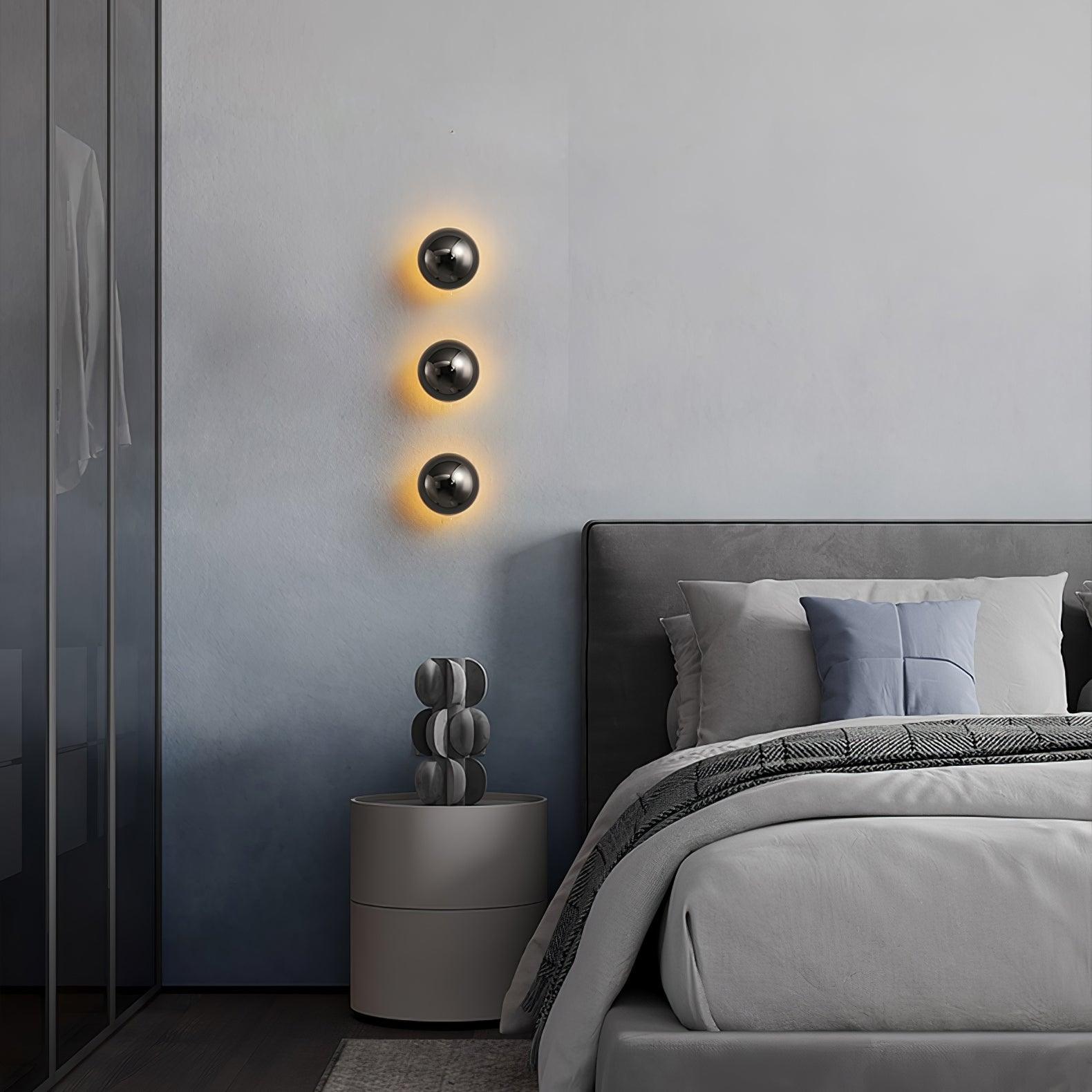 Polished sphere wall sconce with reflective rounded body