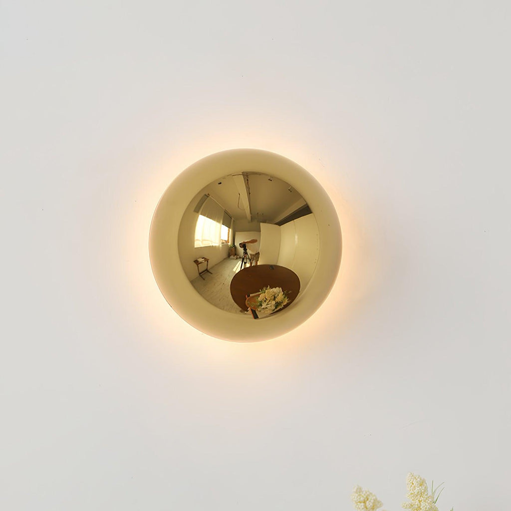 Polished sphere wall sconce shown straight on lit
