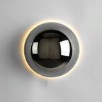 Polished sphere wall sconce with reflective metal finish