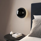 Polished sphere wall sconce shown at an angle