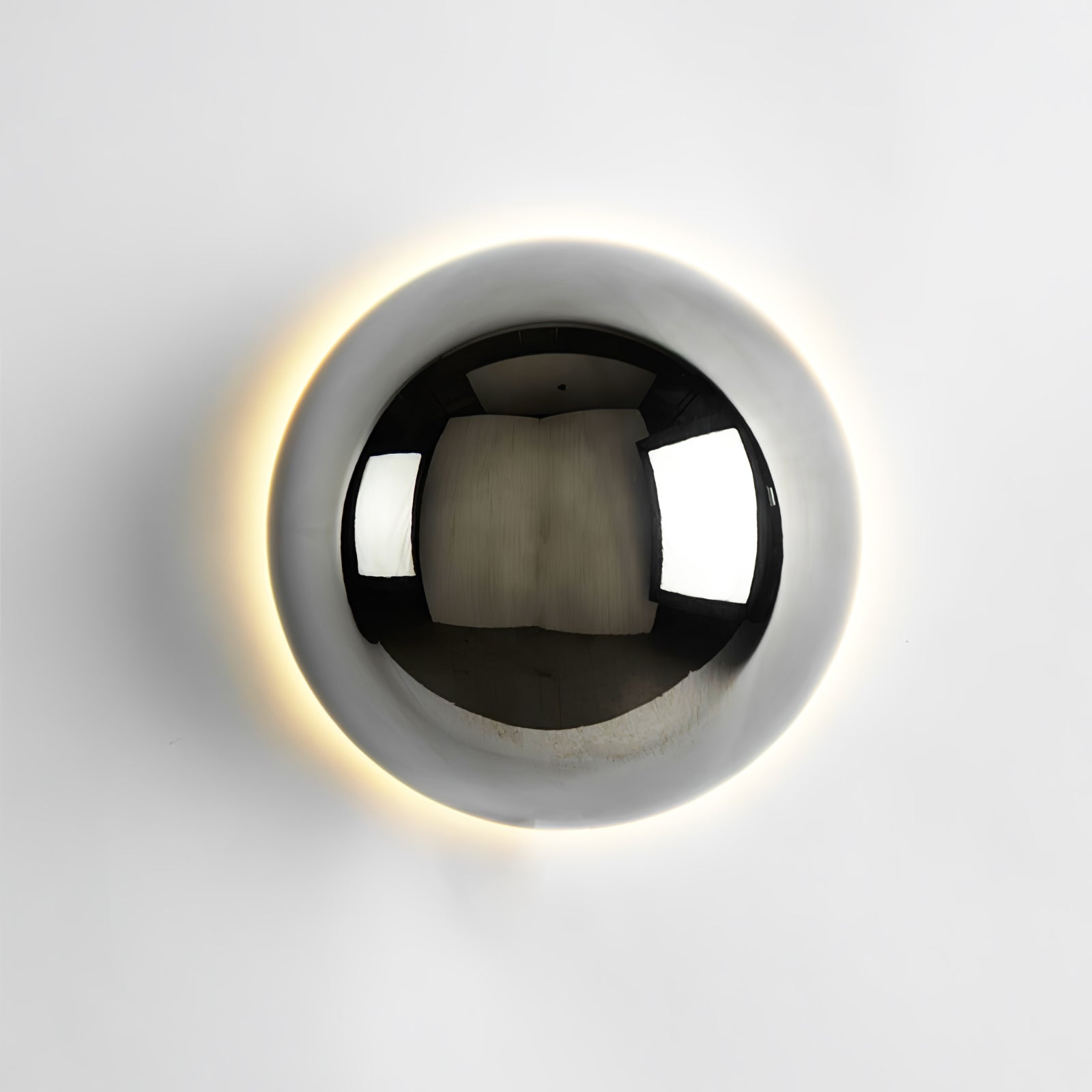 Polished sphere wall sconce showing rounded reflective form