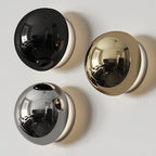 Polished sphere wall sconce glowing in a chic interior