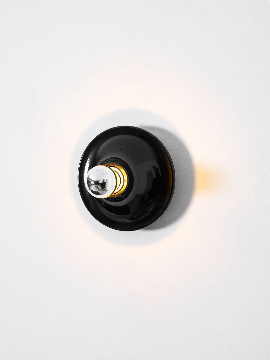 Eclipta wall sconce shown against a clean, plain background