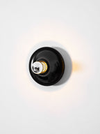 Eclipta wall sconce shown against a clean, plain background