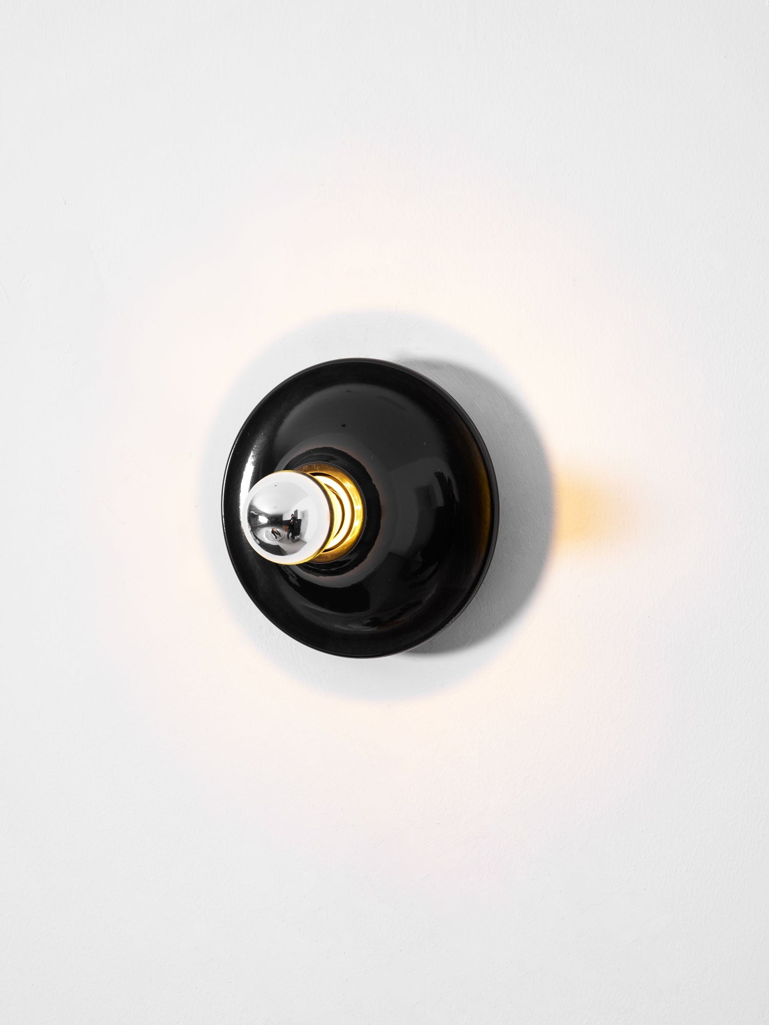 Eclipta wall sconce shown against a clean, plain background