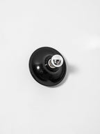 Eclipta wall sconce mounted above a seating area