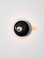 Eclipta wall sconce with its curved base seen in detail