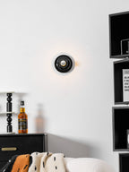 Eclipta wall sconce shown from the side with its mirrored bulb