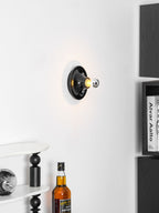 Eclipta wall sconce in a yellow finish against a neutral wall