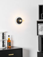 Eclipta wall sconce lighting a sculptural display niche
