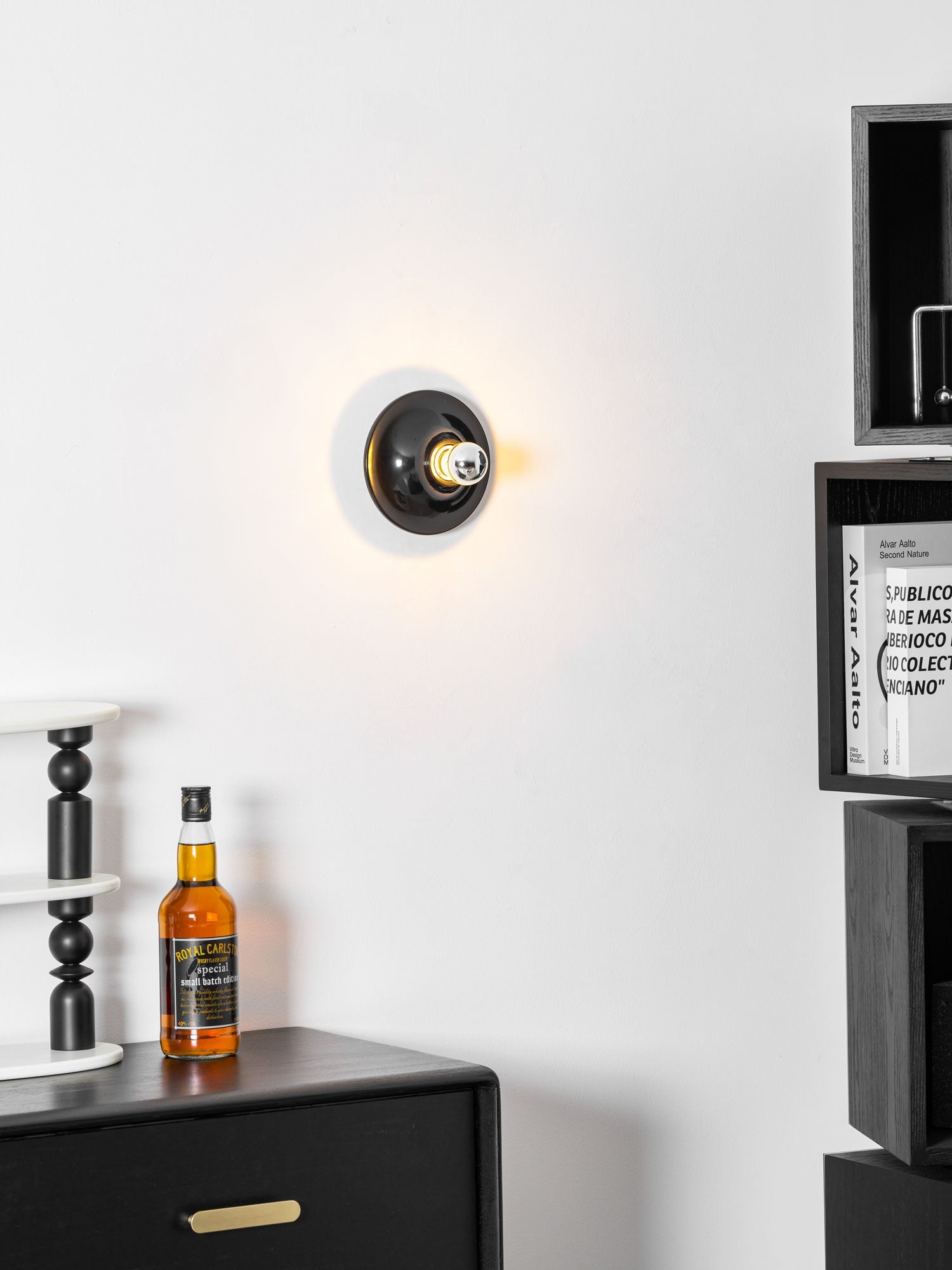 Eclipta wall sconce lighting a sculptural display niche