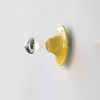 Eclipta wall sconce in a black finish on a textured wall
