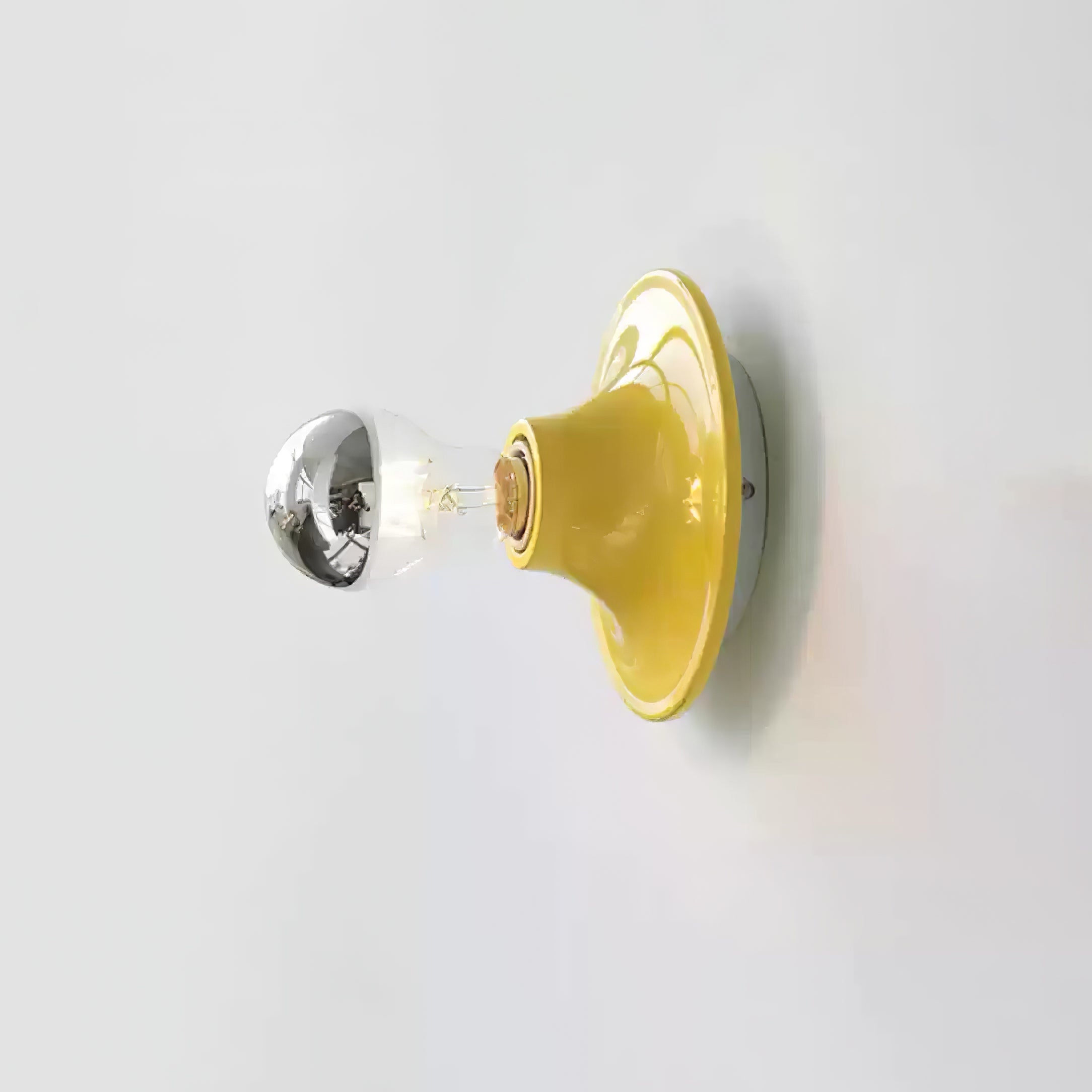 Eclipta wall sconce in a black finish on a textured wall